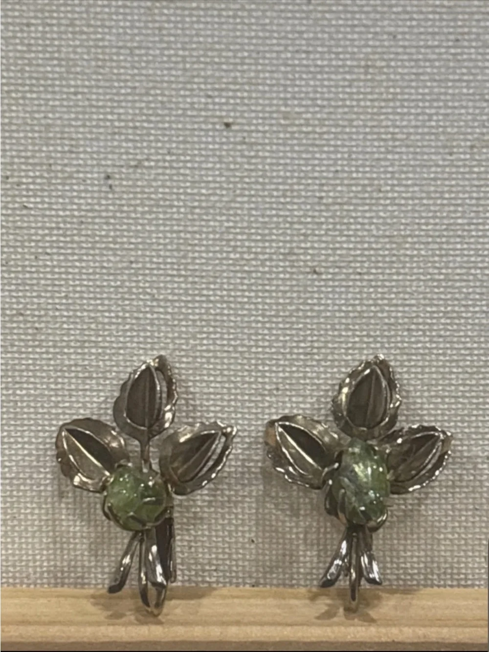 Gold tone leaf clip on earrings with natural peridot gemstone